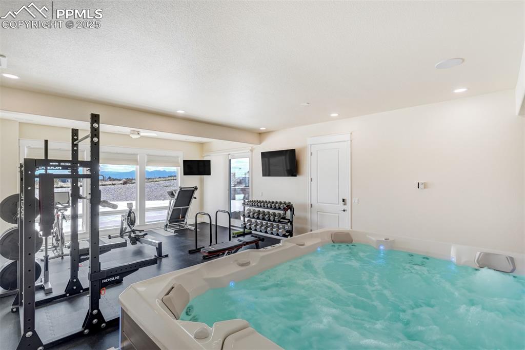 Image 28 of 50: Gym is equipped with a hot tub!