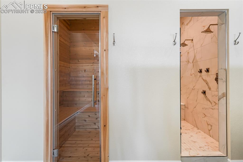 Image 29 of 50: Sauna, Shower, and steam room.