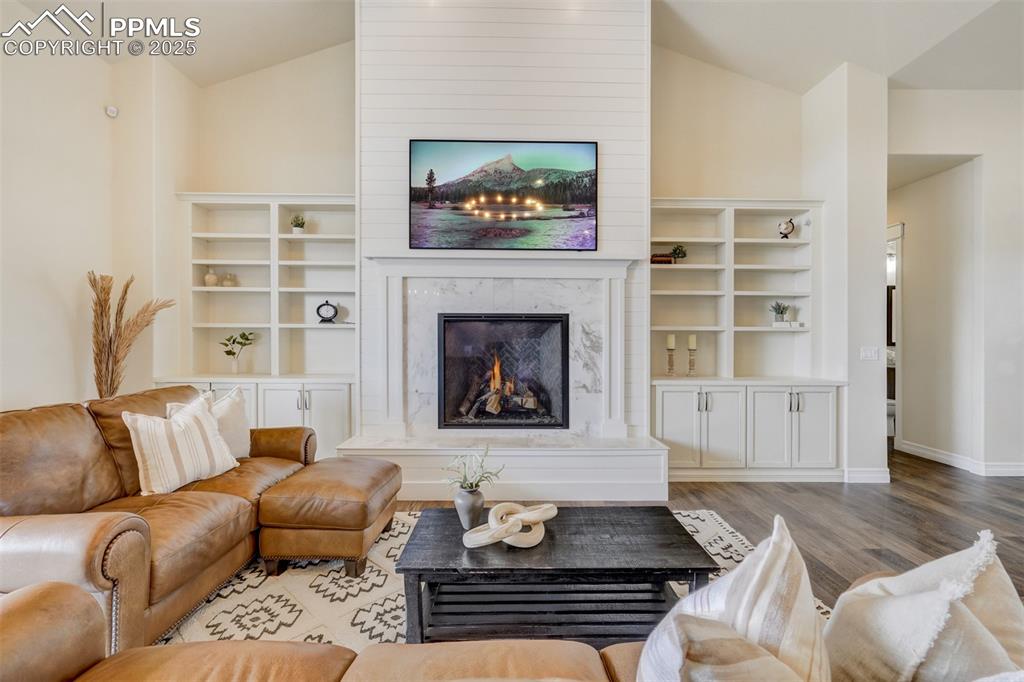 Image 3 of 50: Main level living area with fireplace and built-ins.