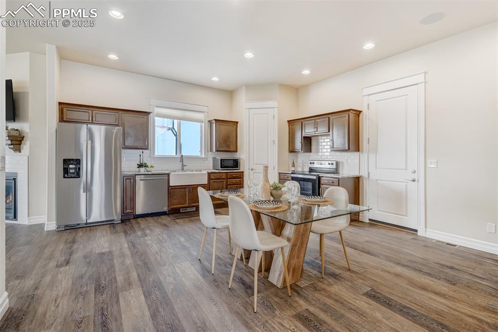 Image 41 of 50: Full kitchen with dining room.