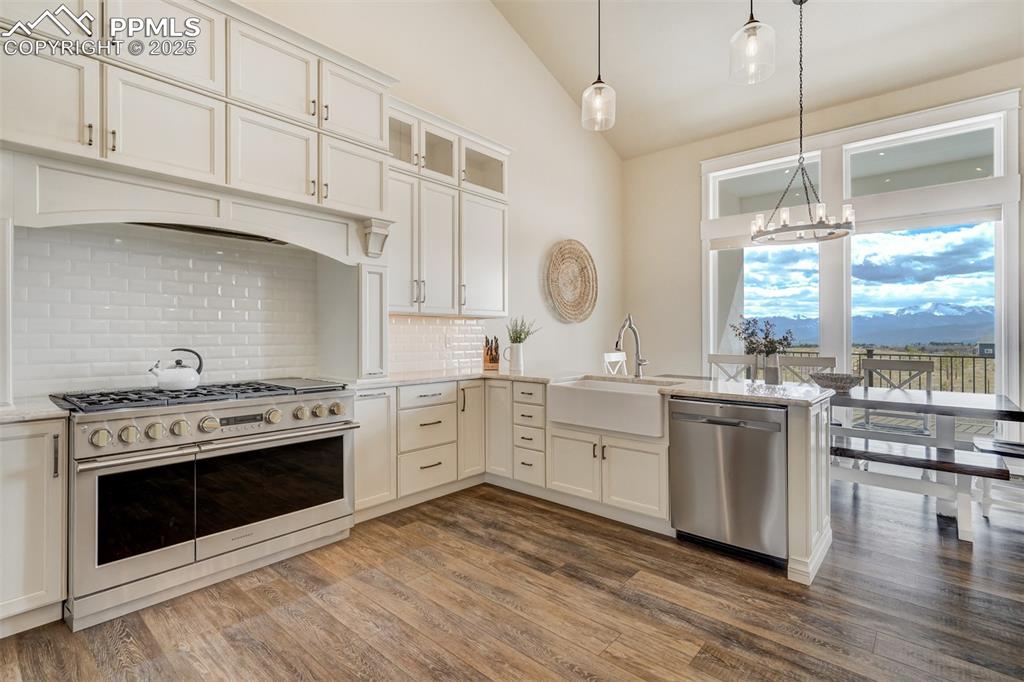 Image 6 of 50: Kitchen featuring a 6-burner Monogram range oven with griddle.