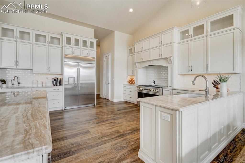 Image 7 of 50: Stone countertops, premium Monogram appliances, pantry, and custom cabinetr