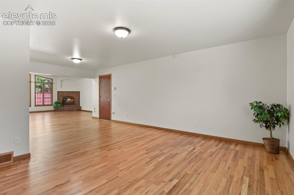 Image 12 of 50: main level-Could be a living room or a formal dining room at the front of t