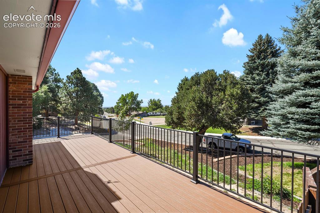 Image 16 of 50: New primary bedroom deck with mountain views