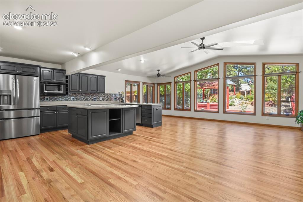 Image 3 of 50: Open floor plan with new refinished oak hardwood flooring