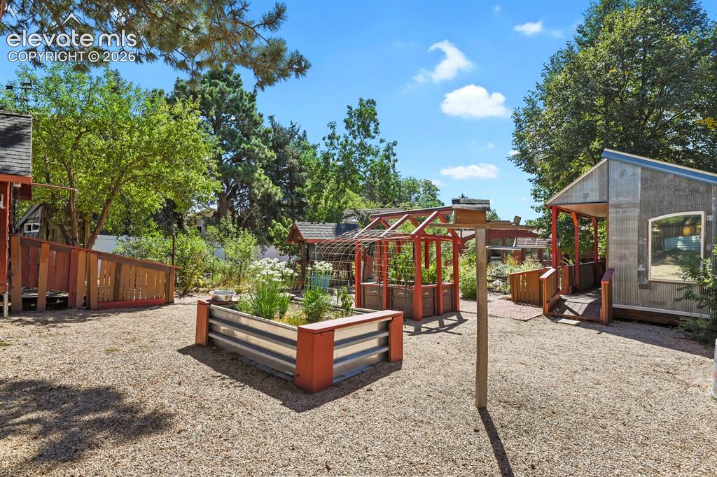 Image 41 of 50: So many garden areas with fruit trees, veggies, & flowers