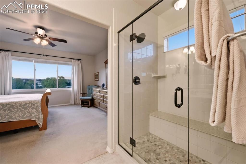 Image 14 of 26: Bathroom featuring ensuite bathroom, a shower stall, light colored carpet,
