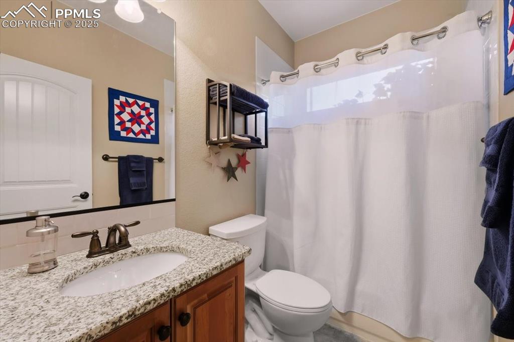 Image 17 of 26: Full bath in basement featuring vanity and shower / bath combination with c