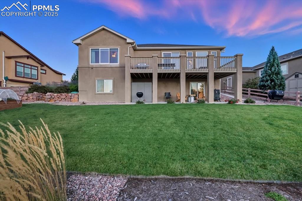 Image 21 of 26: Walk out basement featuring a patio, stucco siding, and a wooden deck
