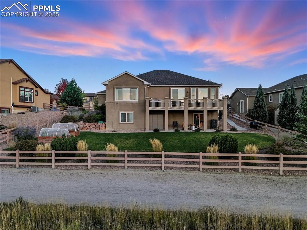 Image 23 of 26: Rear view of property with a patio area, stucco siding, and a fenced backya