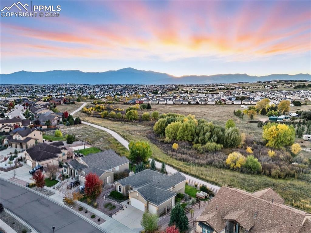 Image 26 of 26: Aerial perspective of suburban area with a mountainous background
