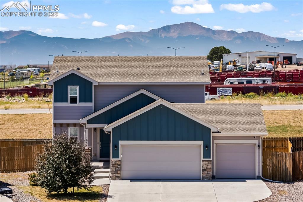 Image 2 of 33: View of front facade with roof with shingles, a mountain view, and board an