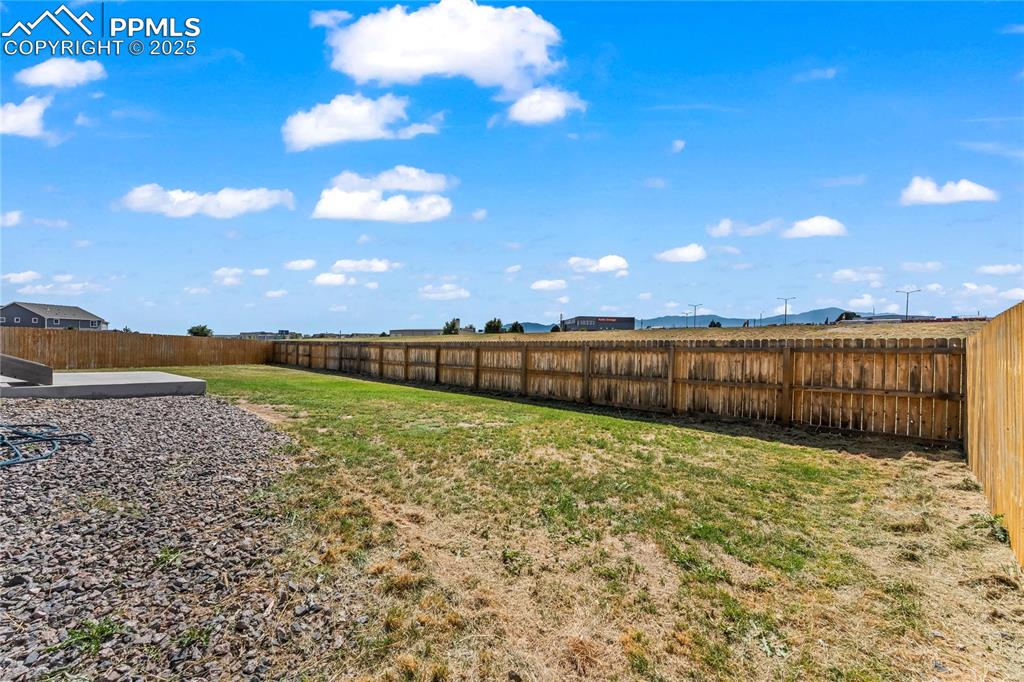 Image 31 of 33: View of fenced backyard