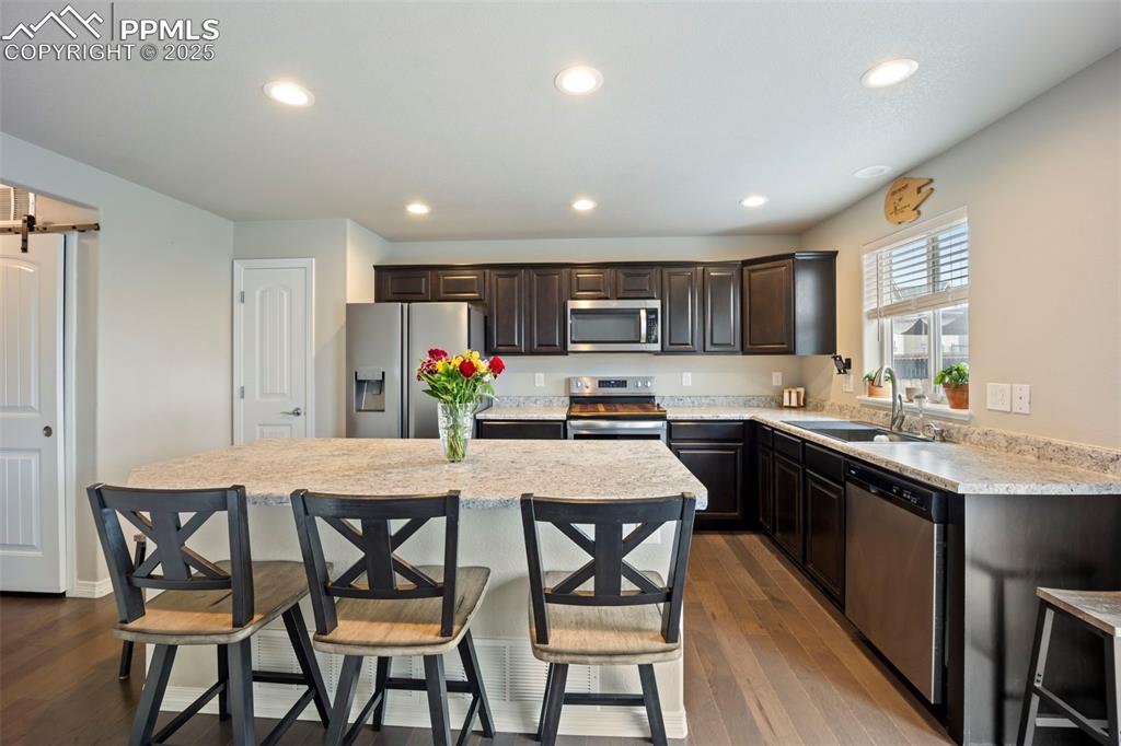 Image 10 of 45: Kitchen featuring appliances with stainless steel finishes, recessed lighti