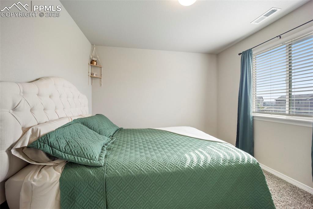 Image 12 of 45: Bedroom with carpet and baseboards