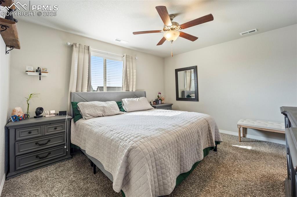 Image 17 of 45: Bedroom with carpet and ceiling fan
