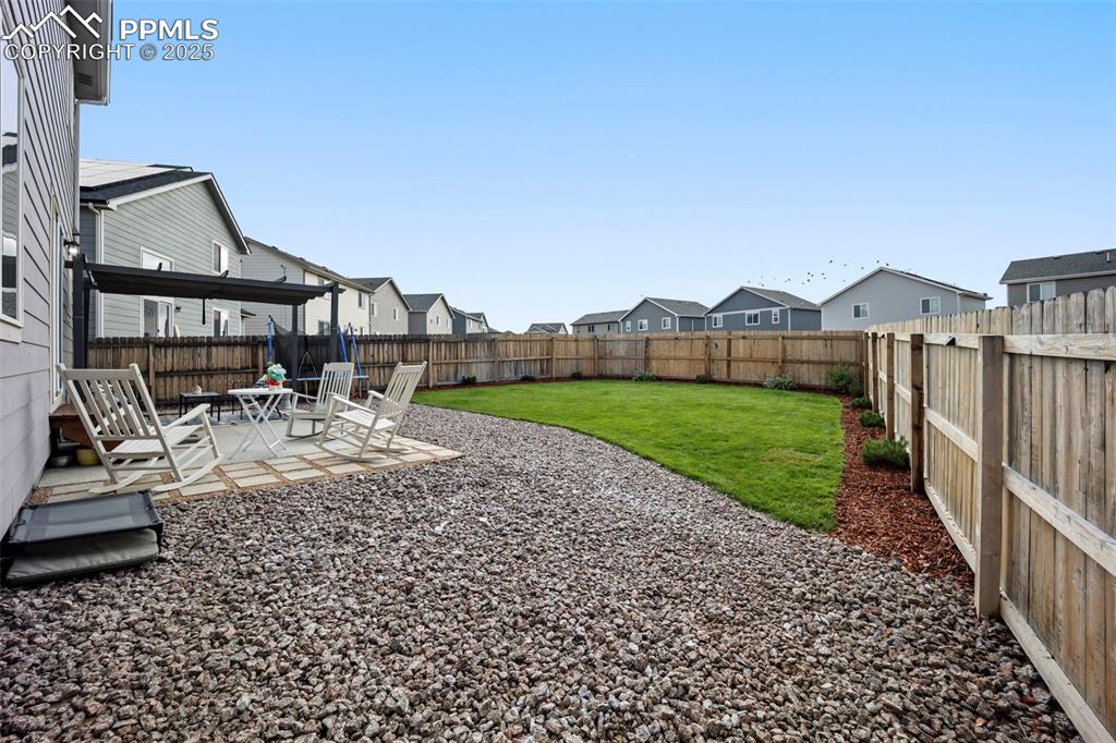 Image 31 of 45: Fenced backyard featuring a patio area and a residential view