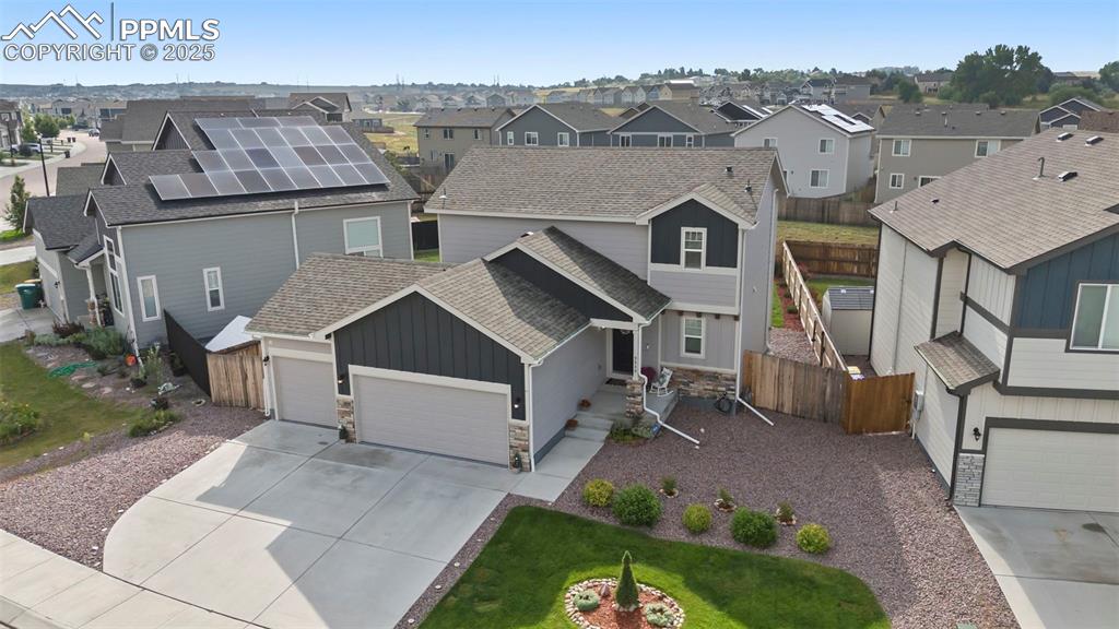 Image 32 of 45: View of front of house with roof with shingles, stone siding, board and bat