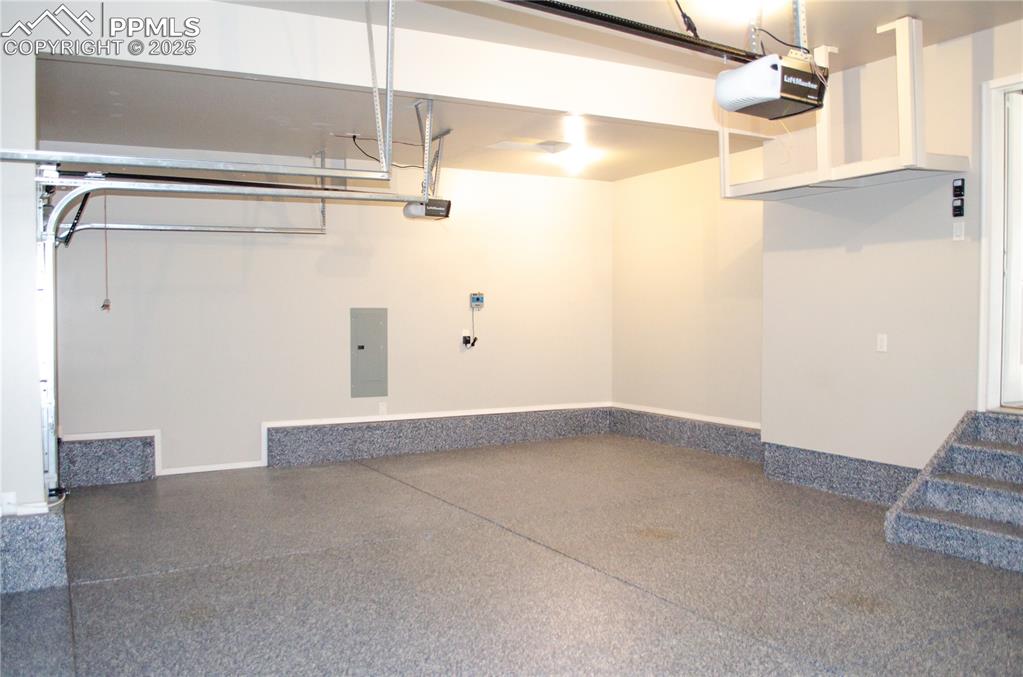 Image 44 of 45: Garage featuring electric panel and a garage door opener
