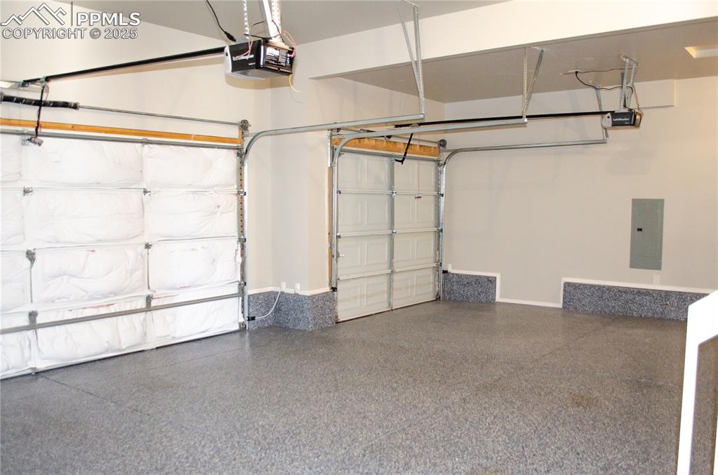 Image 45 of 45: Garage featuring electric panel and a garage door opener