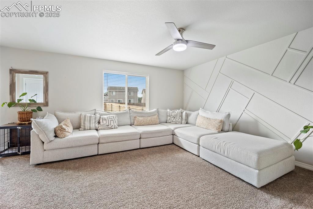 Image 5 of 45: Carpeted living room featuring ceiling fan