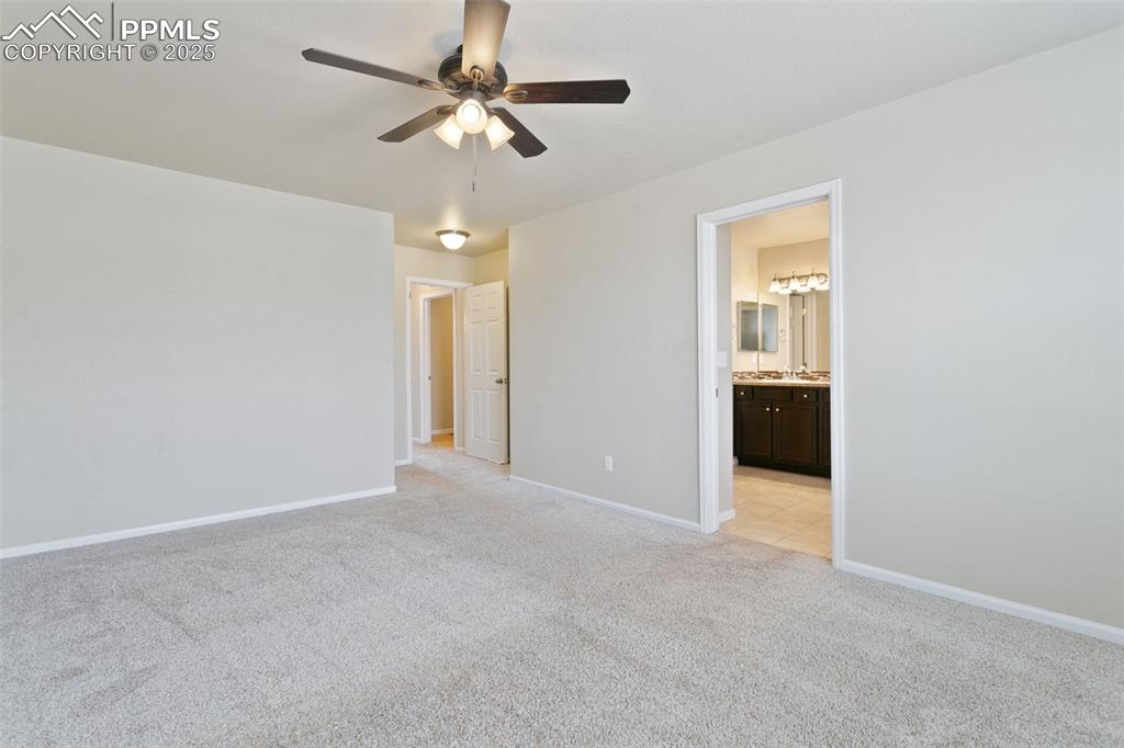 Image 10 of 41: Unfurnished bedroom featuring light carpet, connected bathroom, and a ceili