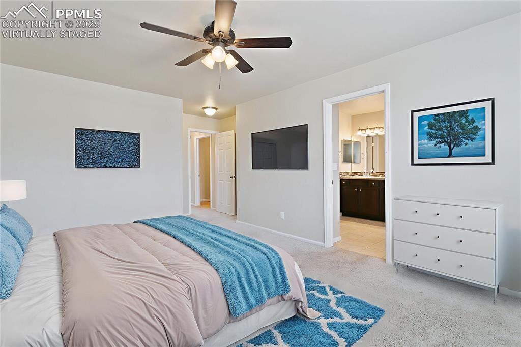 Image 11 of 41: Virtually Staged Bedroom featuring light colored carpet and a ceiling fan