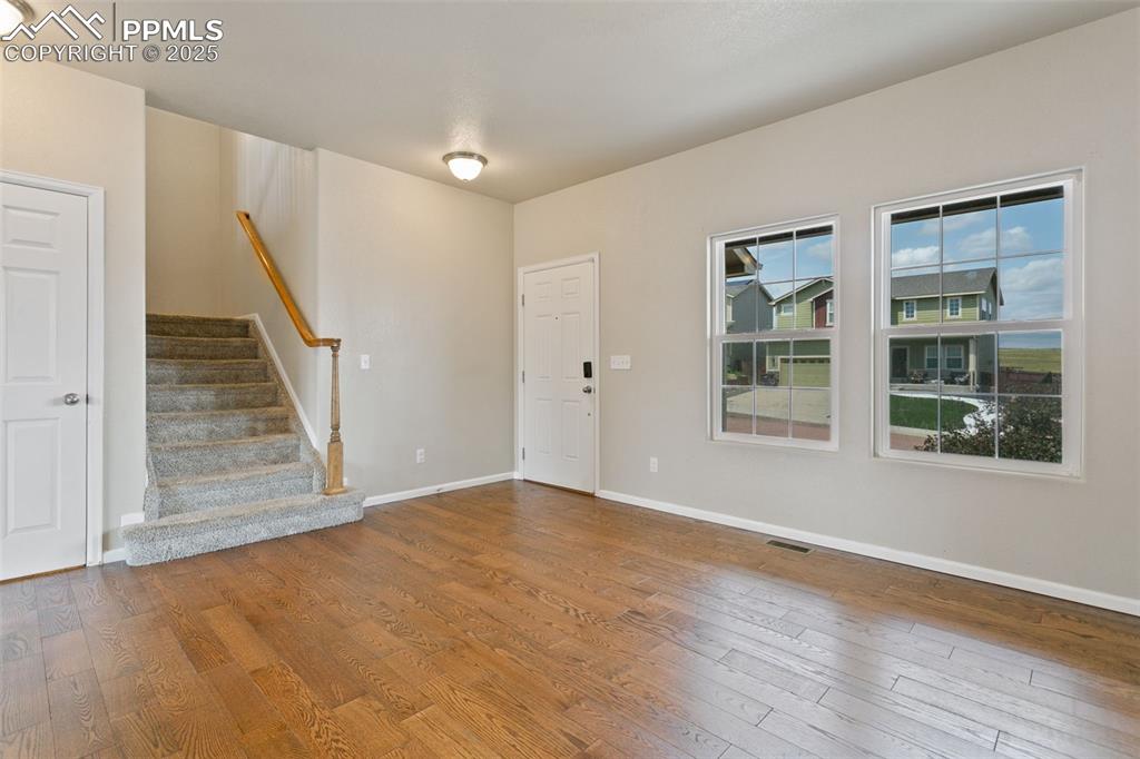 Image 13 of 41: Entrance foyer with wood finished floors and stairs