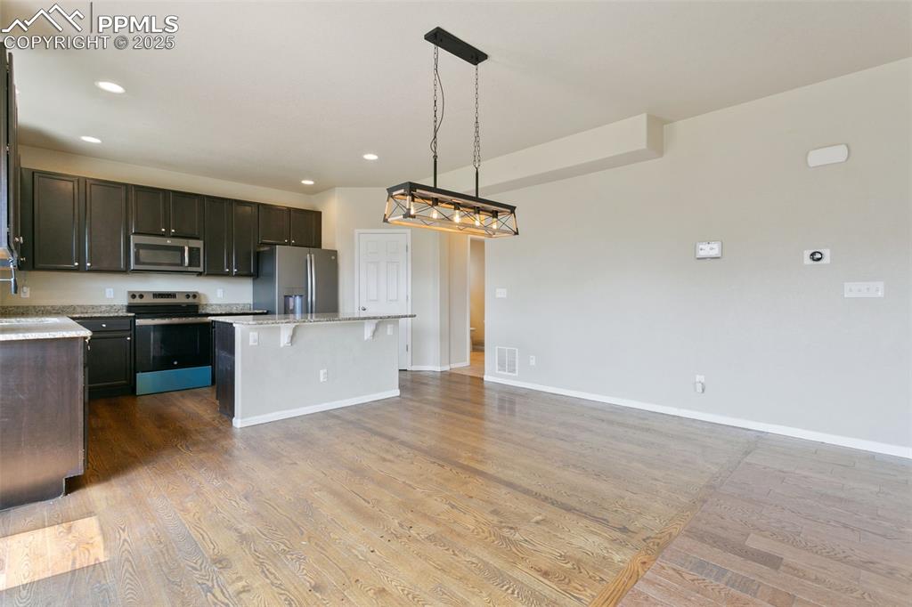 Image 14 of 41: Kitchen with stainless steel appliances, a kitchen island, a kitchen breakf