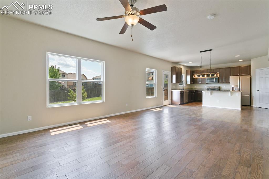 Image 22 of 41: Unfurnished living room featuring plenty of natural light, dark wood-style 