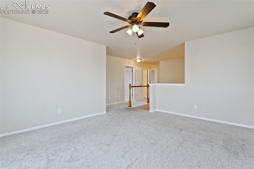 Image 26 of 41: Unfurnished room featuring carpet and ceiling fan