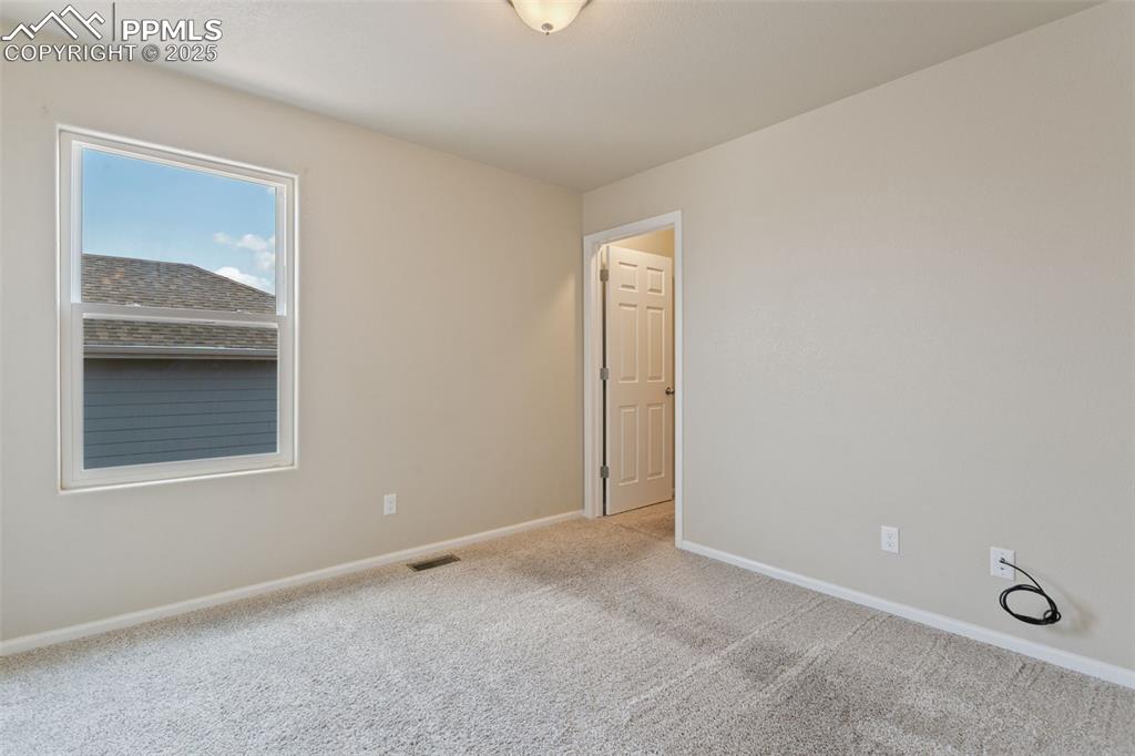 Image 30 of 41: Carpeted spare room with baseboards