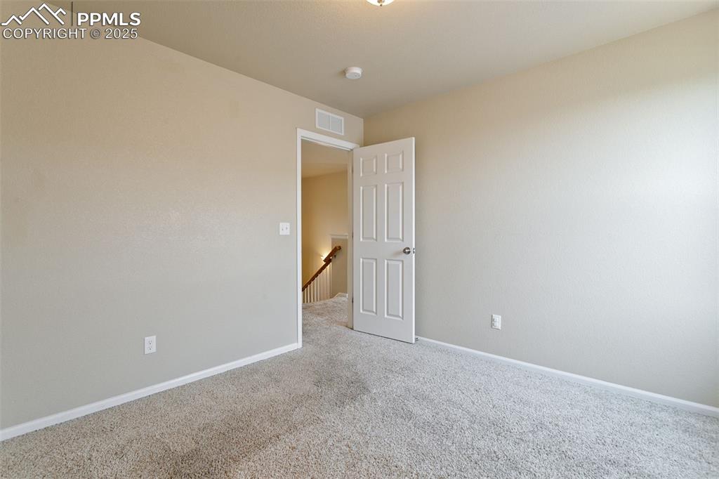 Image 31 of 41: Carpeted empty room with baseboards