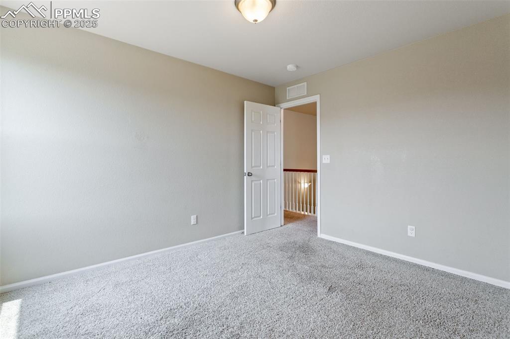 Image 33 of 41: Carpeted empty room featuring baseboards