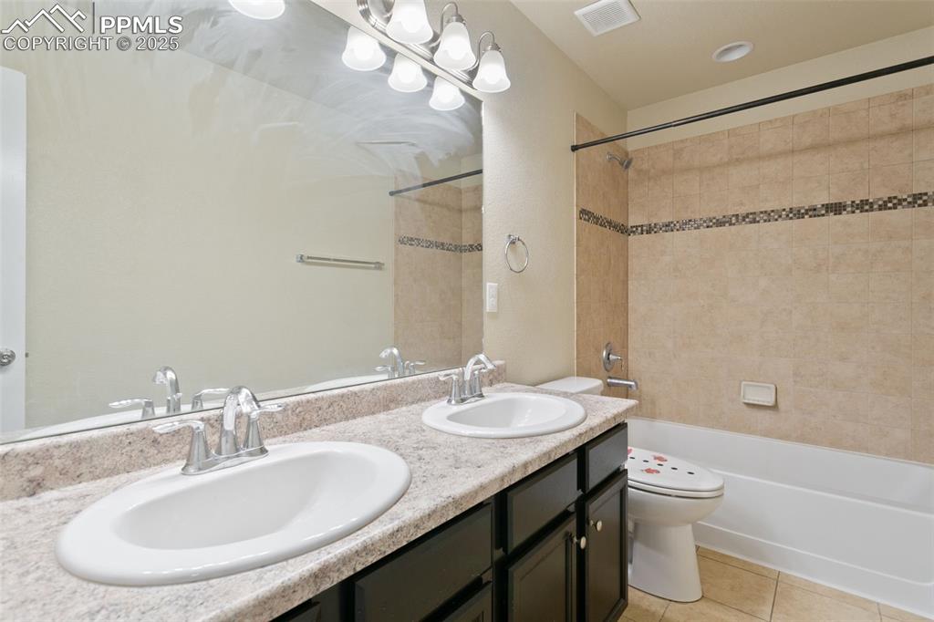 Image 34 of 41: Bathroom with tile patterned flooring, bathing tub / shower combination, an