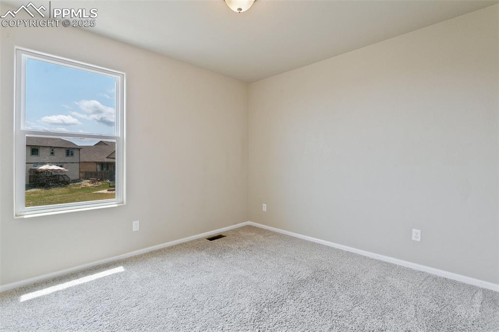Image 35 of 41: Carpeted empty room with baseboards