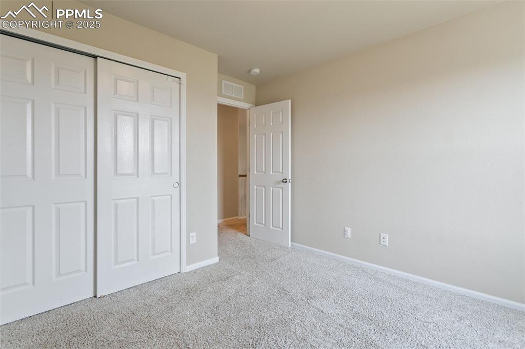 Image 36 of 41: Unfurnished bedroom with carpet and a closet