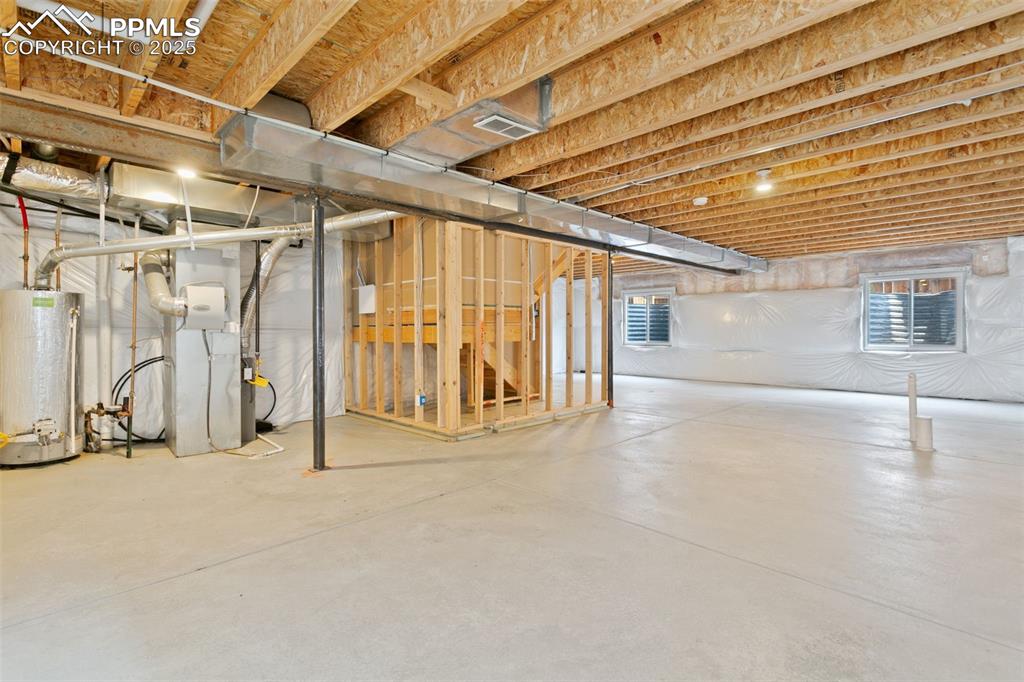 Image 39 of 41: Below grade area with water heater and heating unit