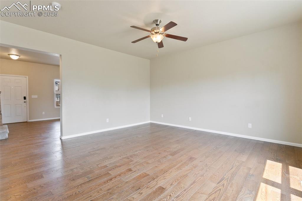 Image 6 of 41: Spare room featuring wood finished floors and a ceiling fan