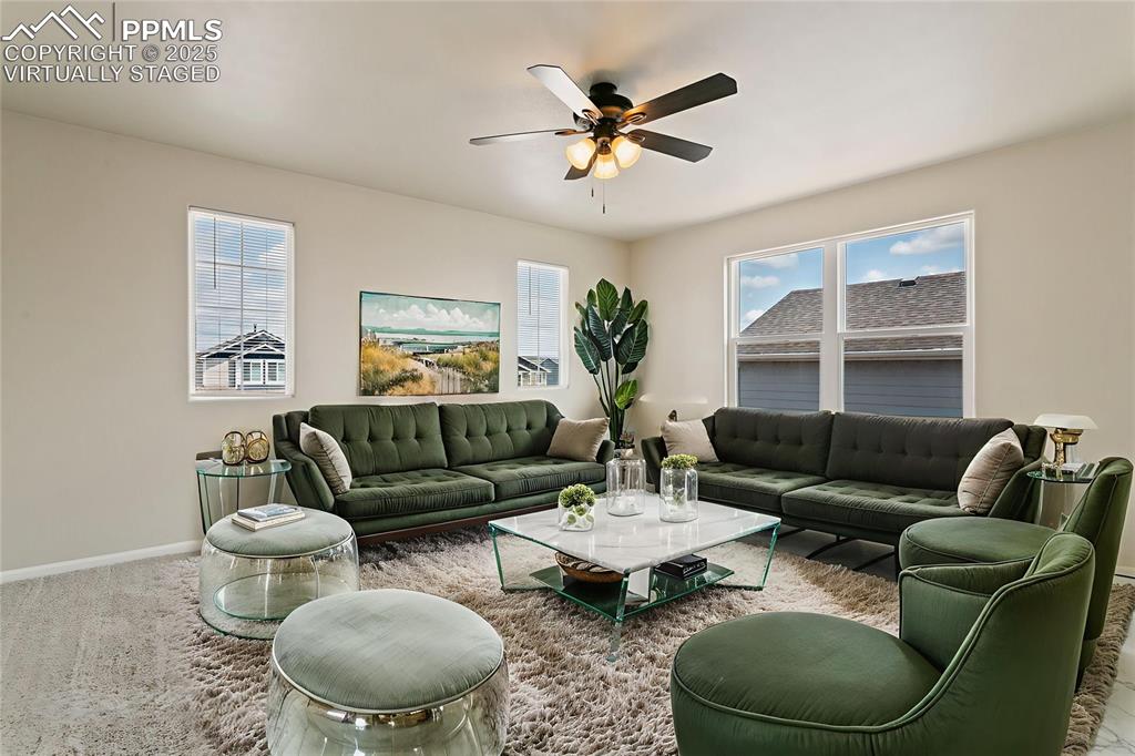 Image 9 of 41: Virtually Staged Living area featuring carpet floors and ceiling fan