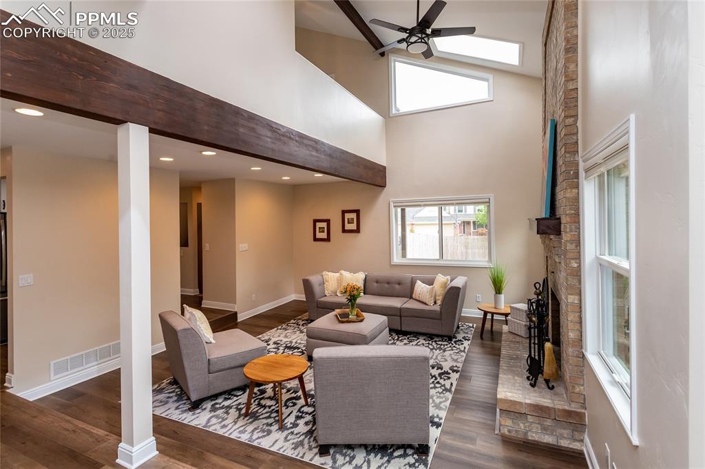 Image 16 of 50: Family room boosts 2 story ceiling with skylights!