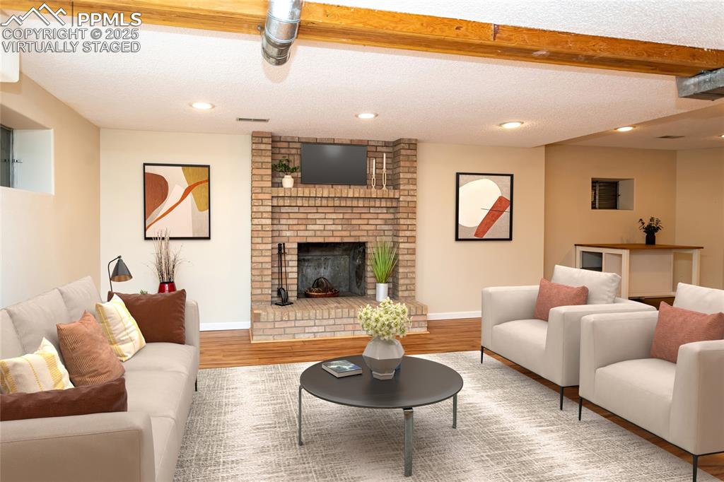 Image 43 of 50: Virtually staged basement family room.