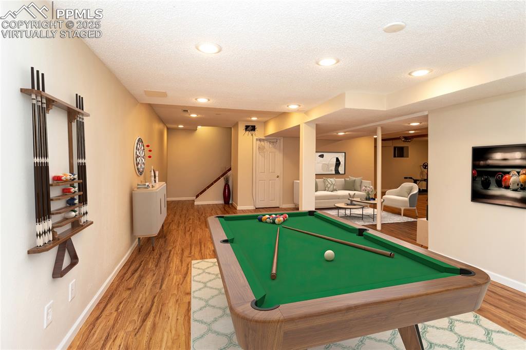 Image 45 of 50: Virtually staged basement game room.