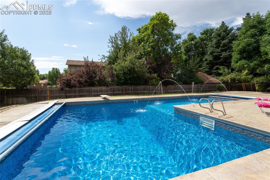 Image 49 of 50: Inviting swimming pool has lighting and water features