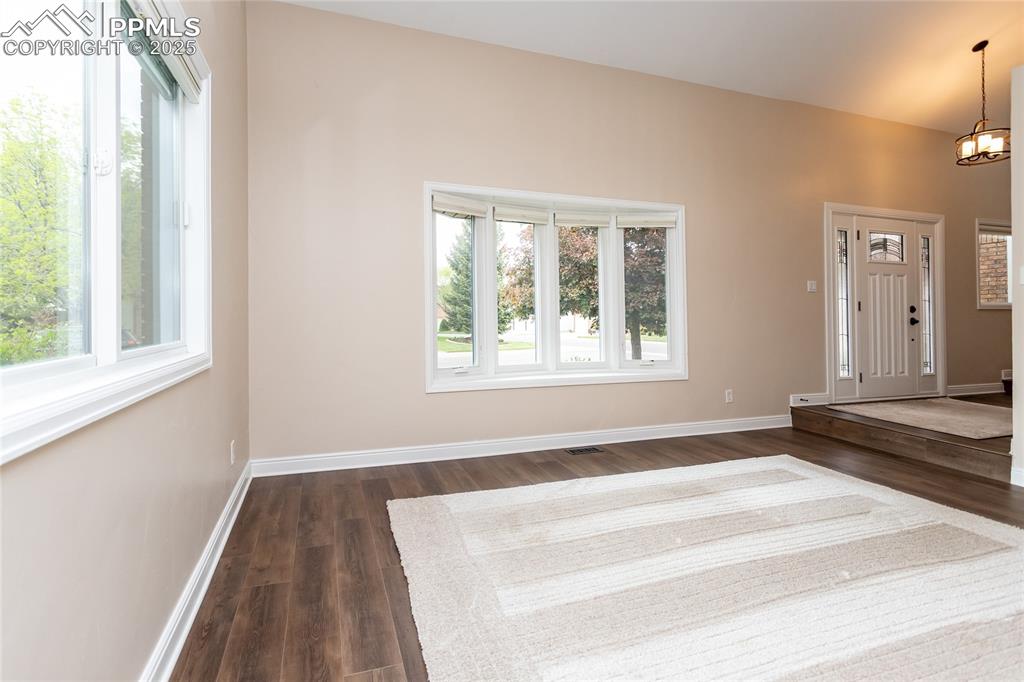 Image 8 of 50: Formal living room has large windows bringing in the light.