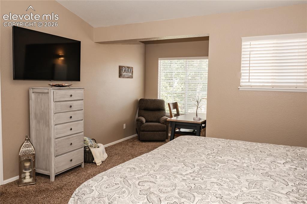 Image 20 of 34: Primary bedroom features bonus area for office or cozy reading nook