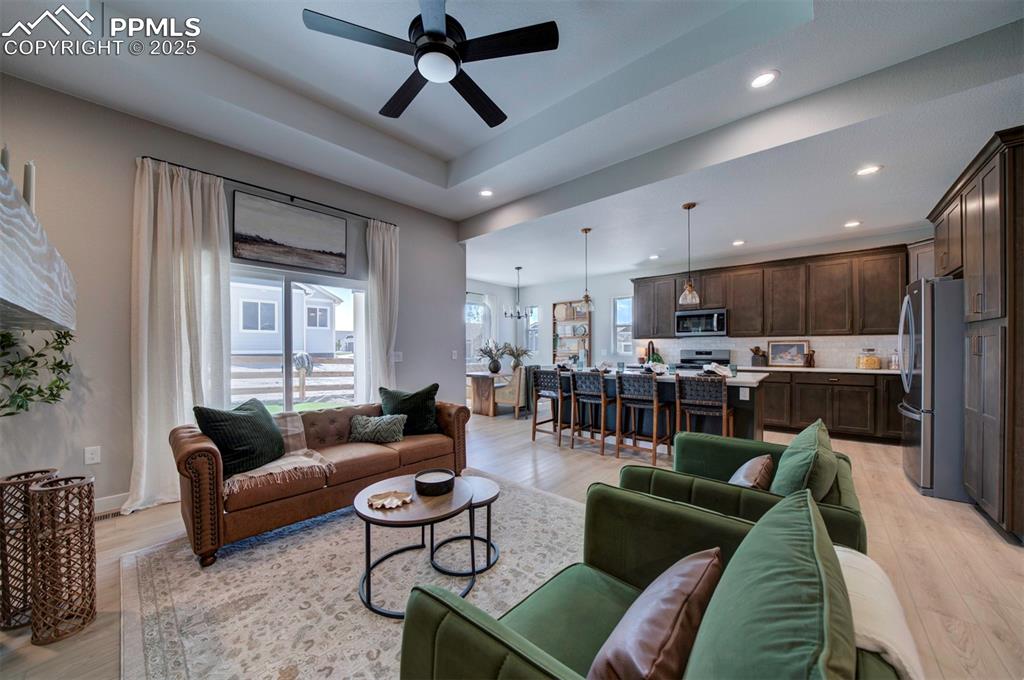 Image 13 of 44: Living area with recessed lighting, light wood-style floors, and ceiling fa