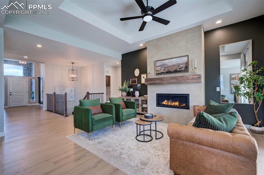Image 16 of 44: Living room with recessed lighting, wood finished floors, ceiling fan with