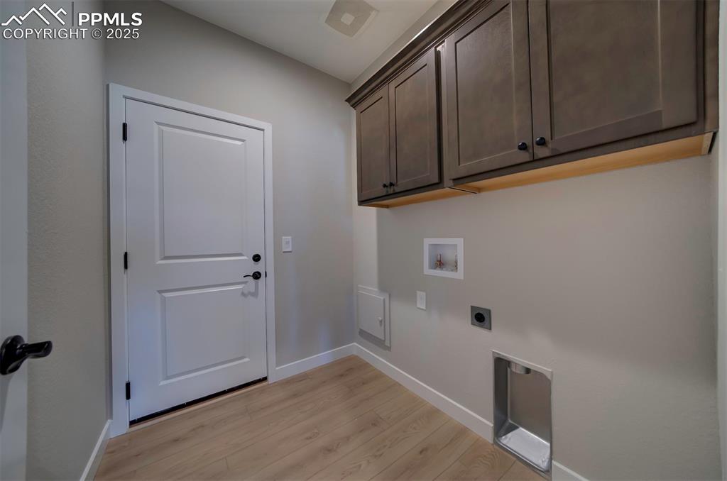 Image 23 of 44: Laundry area with baseboards, light wood-type flooring, electric dryer hook