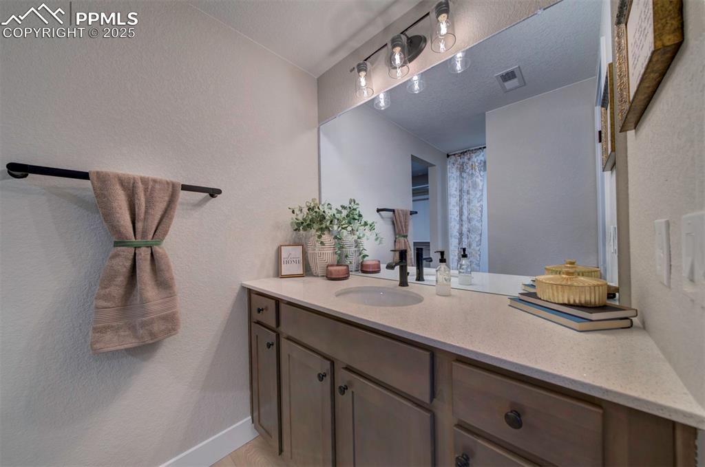 Image 40 of 44: Full bath with baseboards, visible vents, and vanity